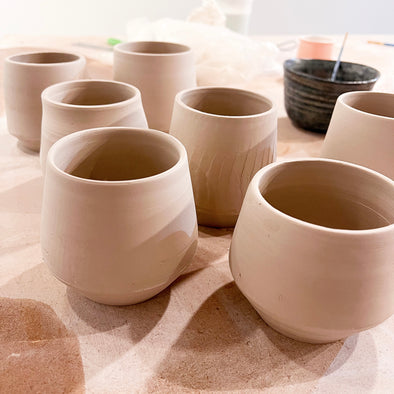 ceramic cups waiting to be glaze decorated