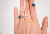 teal rings modeled on hand