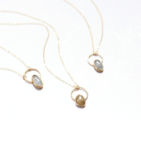 three stone necklace pendants, aquamarines and one sapphire